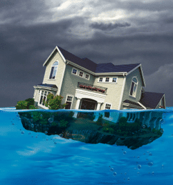 A house floating in the water under a cloudy sky.